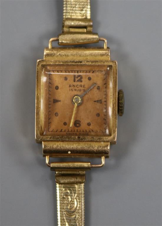 A ladys 18ct gold Ancre manual wind wrist watch, on a gilt metal bracelet.